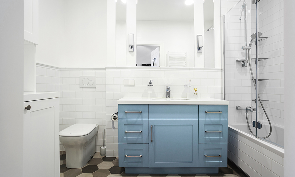 Pastel coloured vanity design in white bathroom with drawers lends a clean look to the area.