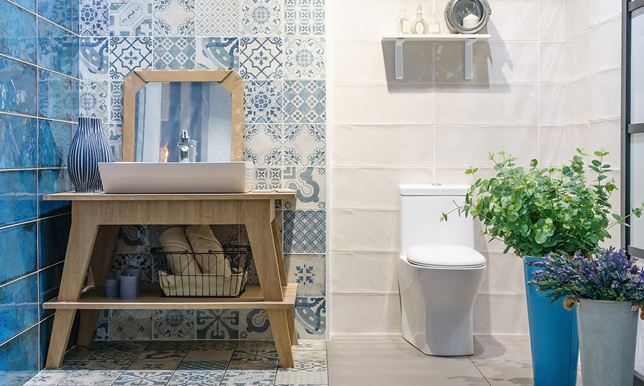 The small bathroom vanity cabinet design in wood and has a patterned tile background creates an aesthetic look.