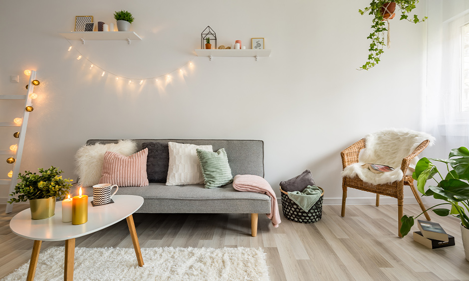 A Scandinavian living room with lighting and candles creates an illusion of a spacious room.