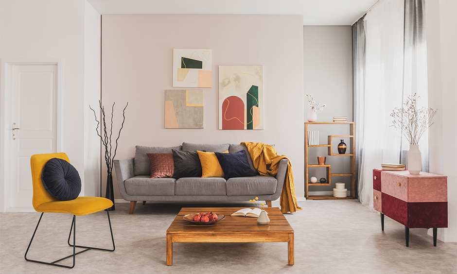 Scandinavian living room with colourful cushion, chair and grey sofa complements the minimalist style.