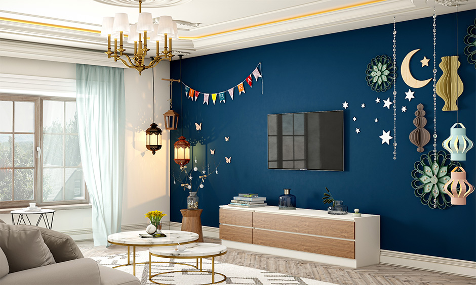 Eid DIY decorations on the living room wall with stars and a crescent moon made from origami papers look vibrant.