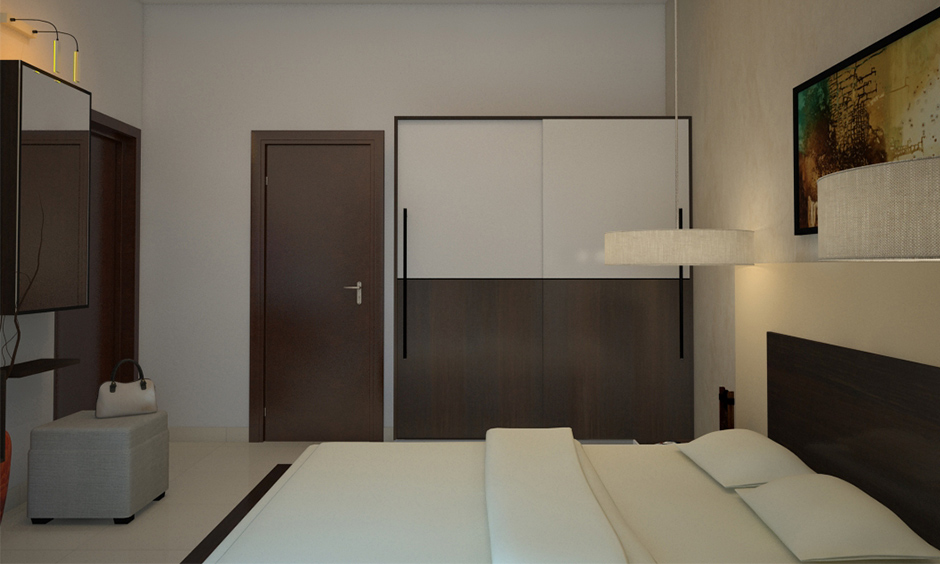 Wooden corner almirah design with sliding doors in white and brown colour laminates looks aesthetic in the small bedroom.