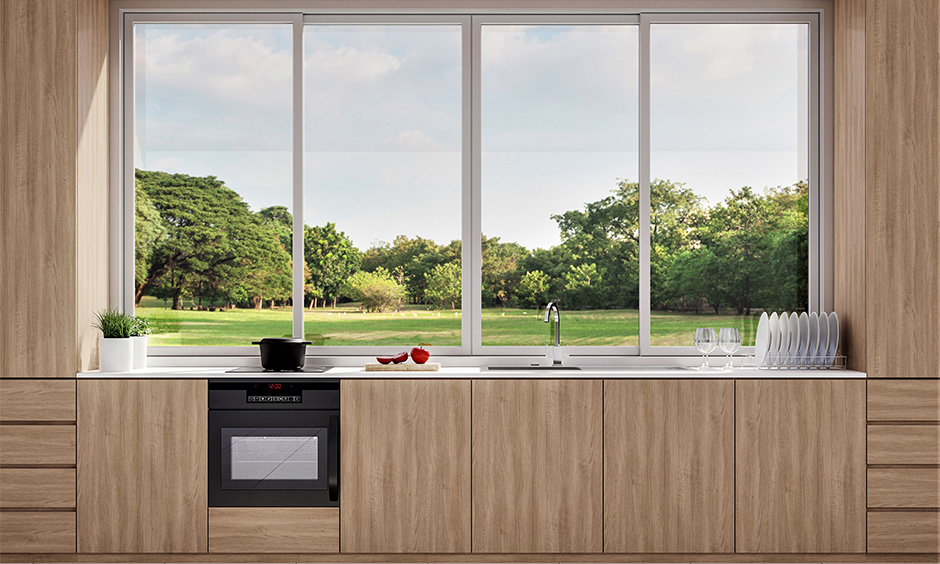 Sliding windows glass design in the one-wall minimal kitchen look airier and brighter.