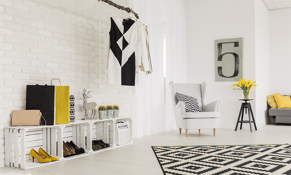 Space-saving living room idea, white living room with DIY shoe rack cum shelve adds a creative look to the place.