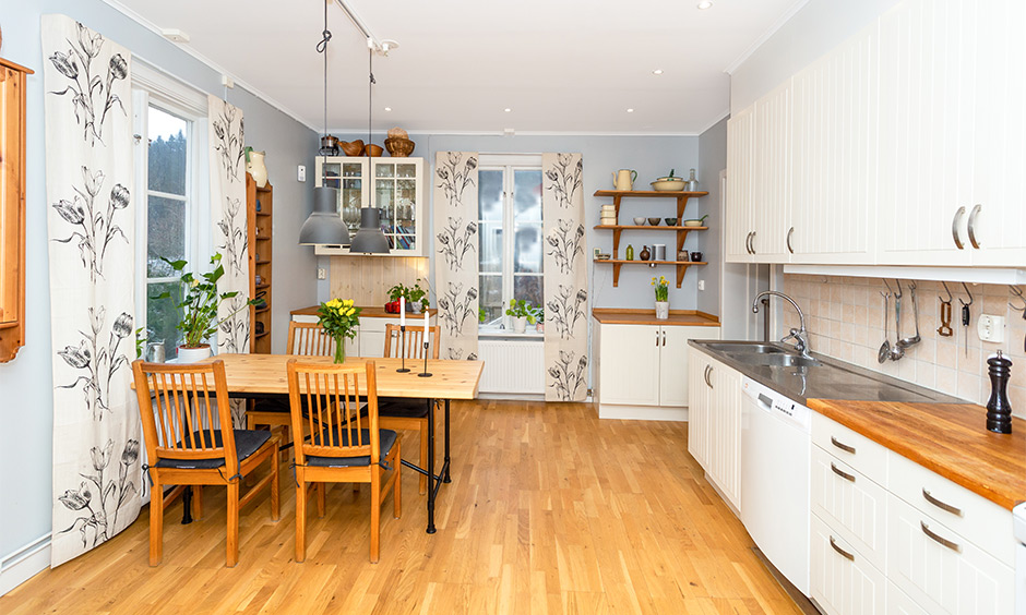 Spring decor for kitchen cum dining area window with flowy pattern drapes way of inviting spring into your homes