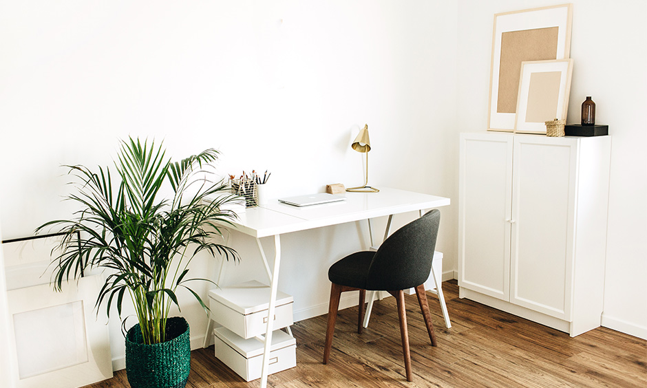 Study table organization idea with solo white cabinet allows holding essentials and creates a clean look.