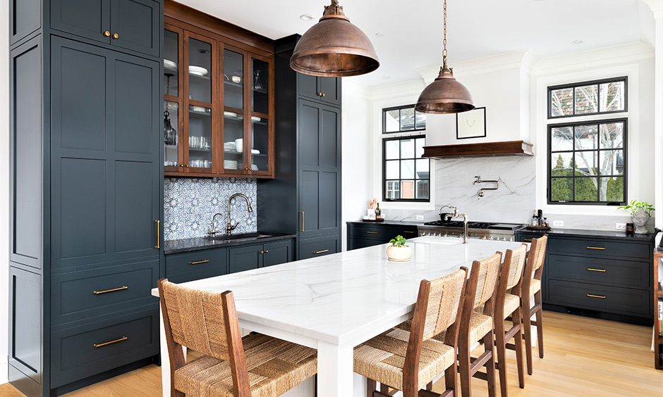 Vintage style kitchen cabinets in dusty blue colour and a marble-top dining table brings an old-school vibe.