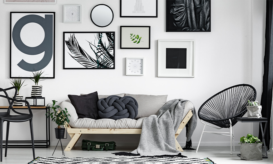 White Scandinavian living room with painting frames on the wall lends an aesthetic look to the area with unique furniture.