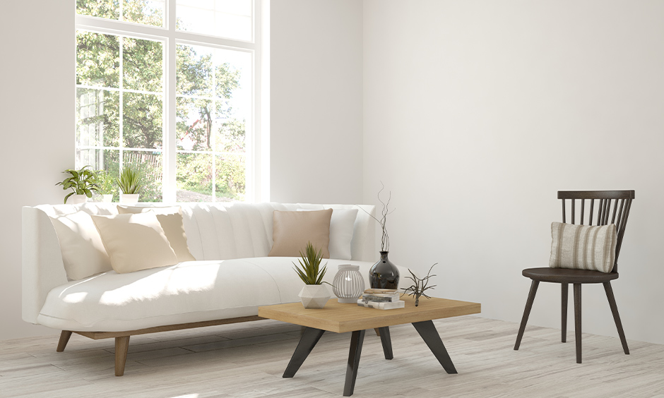 White Scandinavian living room with simple wooden furniture and minimal accessories lends a welcoming vibe.