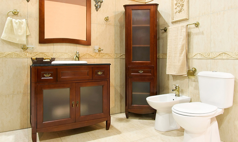 Wooden bathroom vanity designs India in warm natural colour look very retro and vintage with ornate towel hangers.