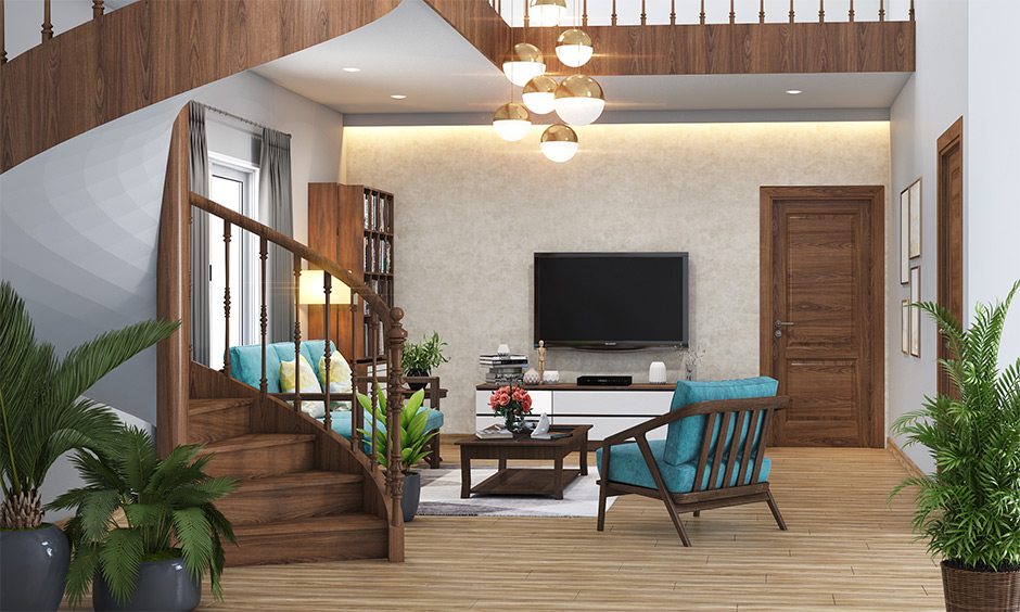 Spiral staircase design India made from wood adds warmth to the entire home with wooden flooring and pendant lights.