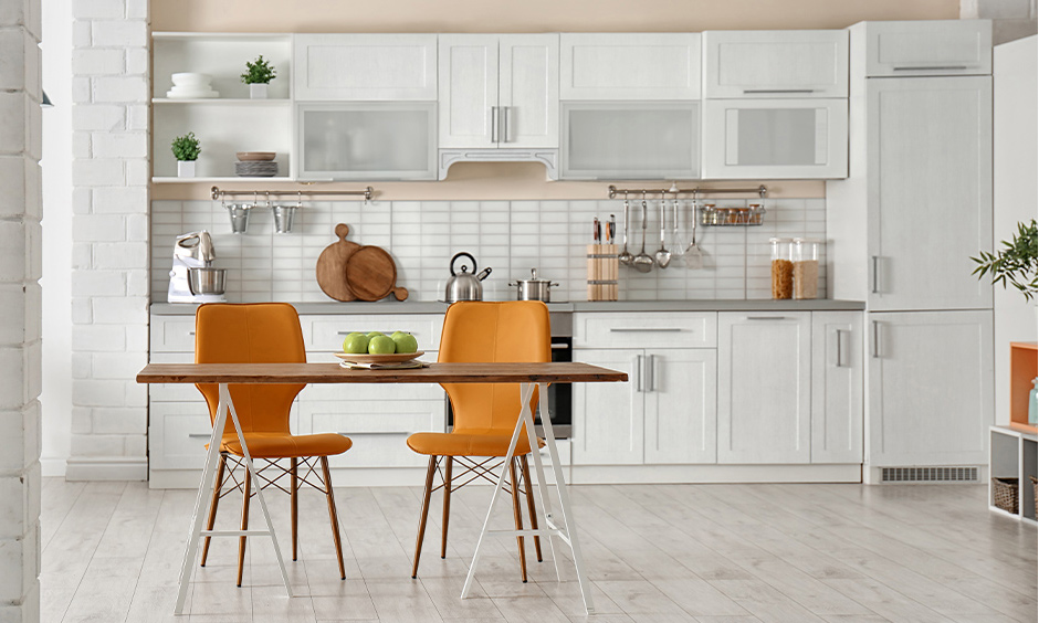 Wooden top space-saving dining table for 2 with folding option and plastic chairs save some more space.