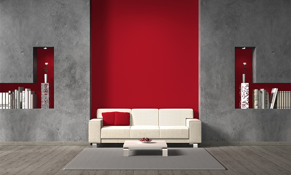 Grey and red colour combination wall paint with white sofa create a luxury look to the area.