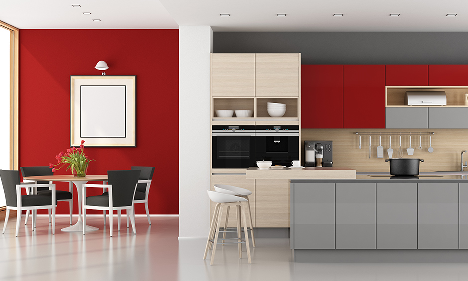 Open kitchen cum dining area in grey, red and white wall paint combinations brings a bold vibe.