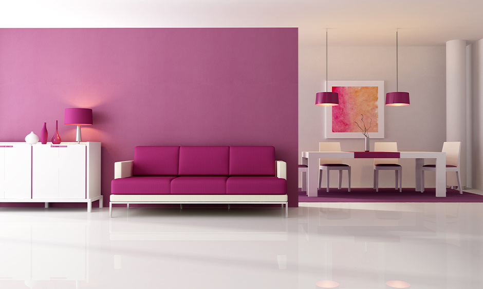 White and purple wall color combination with matching furniture and lights in living cum dining area look eye-catchy.