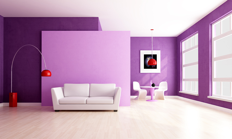 Purple wall colour combination with red and white accent furniture and lamps in the minimalist living room looks chic.