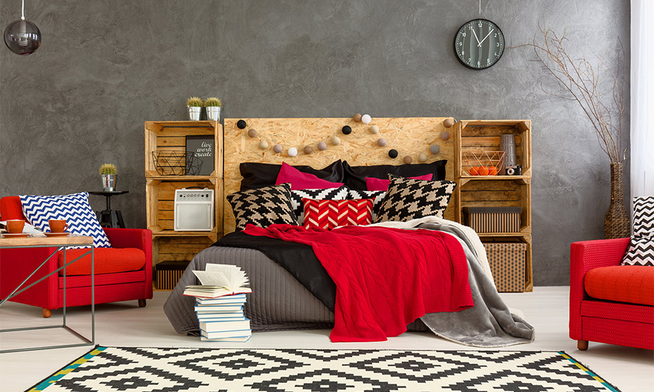 Armchairs and bedsheet in red accent bedroom design bring a bohemian touch to space with minimal elements.