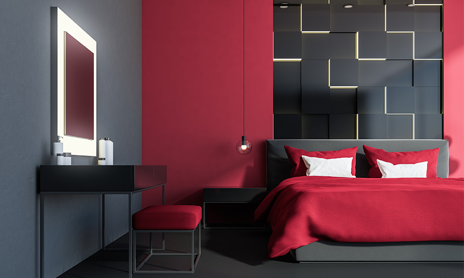 A red and grey bedroom design with a modern dressing table looks clean and vibrant.