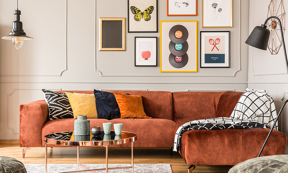 Retro-style home decor wall with photo frames, framing gramophone discs and large paintings that adorn the walls.