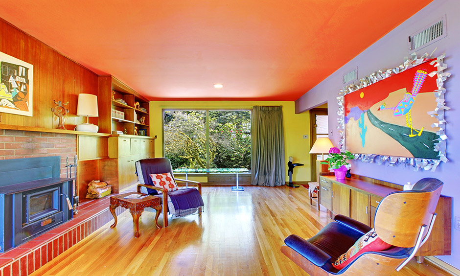 A room in retro style interior design with a mix of bright colours walls and classic furniture lend a splendid look.