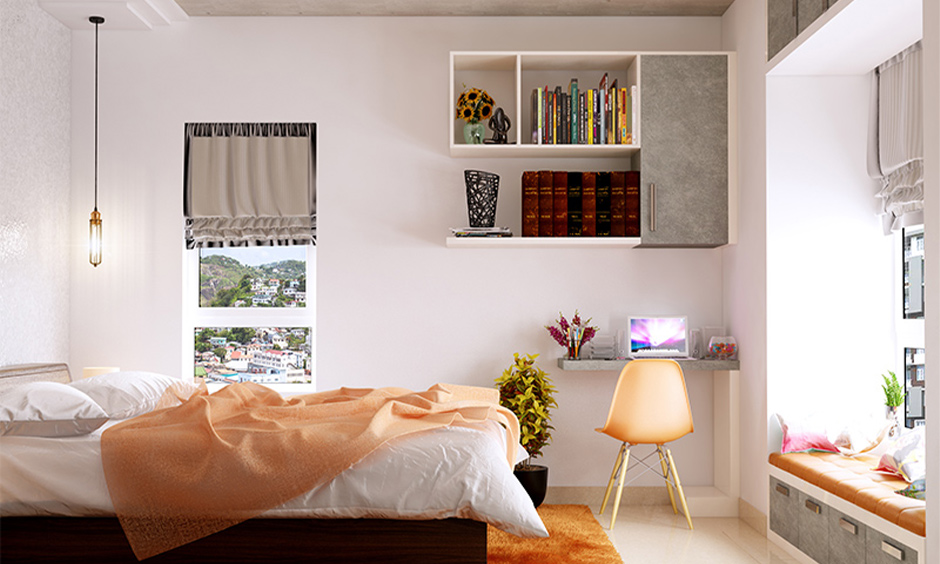 A small study table in bedroom ideas with a floating bookshelf unit and a plastic bucket chair looks elegant.