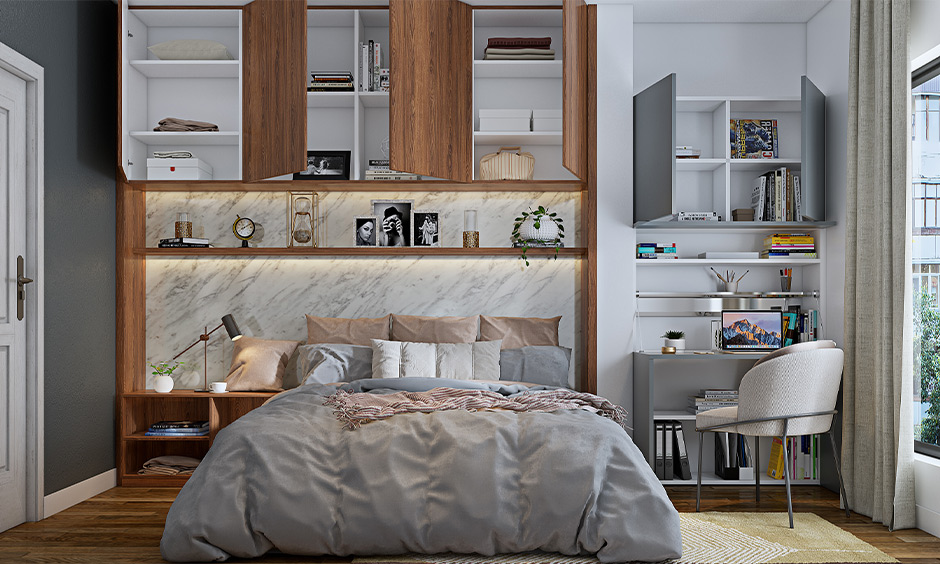 Small study table in bedroom designed with a shelf and cabinet lends a chic look.