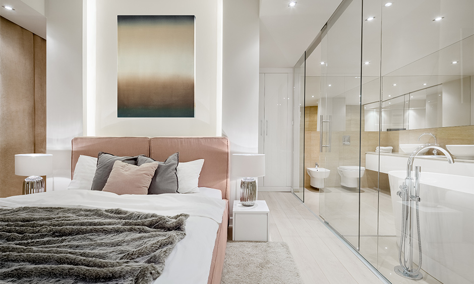 The bedroom with sliding glass door that opens up to the bathroom space looks incredibly stylish.