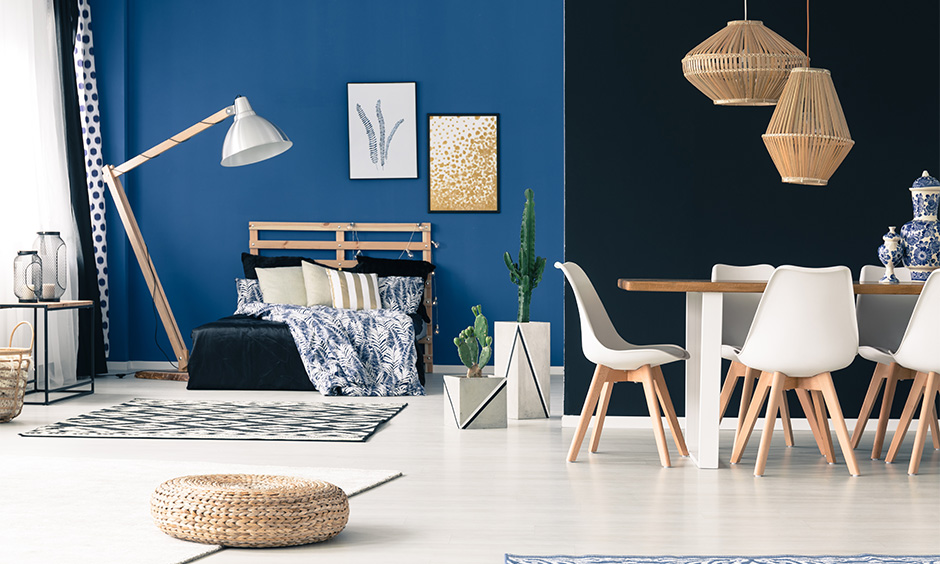 Bedroom cum dining area with dark interior colour in navy blue paired with white look refreshing.