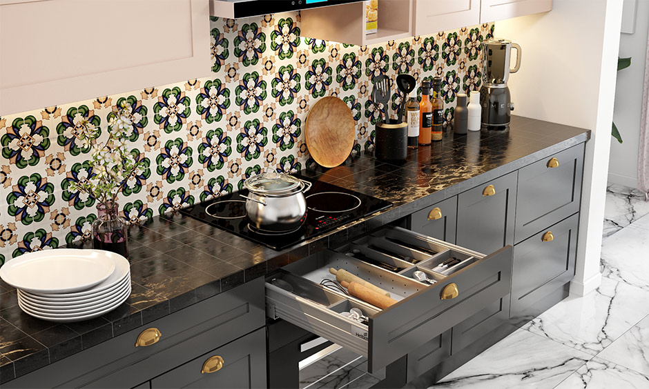 The kitchen black tile countertop looks sleek and easy to maintain.