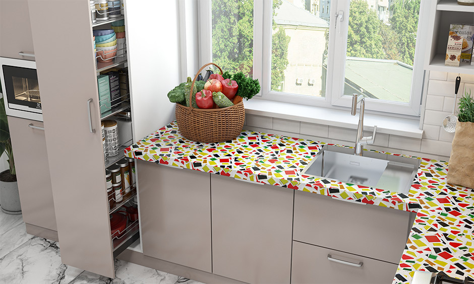 A broken mosaic tile kitchen countertop turns the cooking area into a party of colours, patterns and textures.