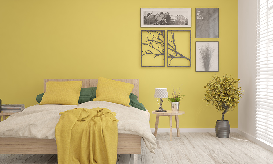 Yellow and grey bedroom decor with artworks