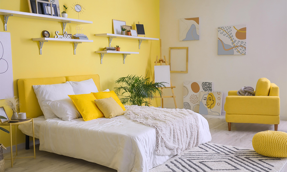 Yellow bedroom decor with artwork in pastel colours