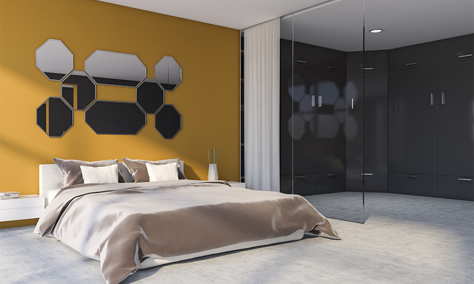 Yellow bedroom decor with different shaped mirrors on wall