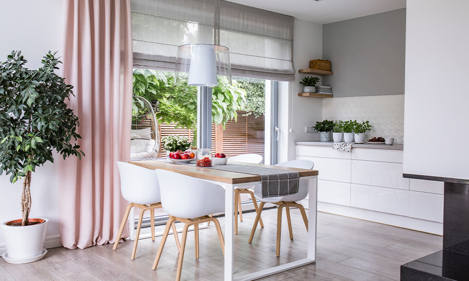 All season-best kitchen design for a middle class with a pop of light pink on the curtains adds a charismatic effect.