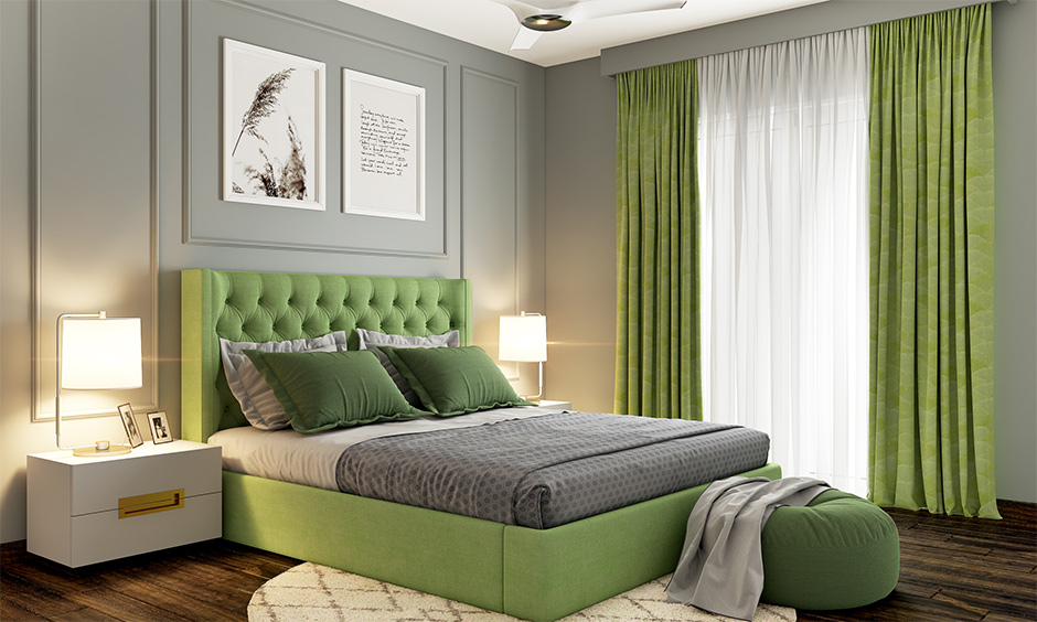 A grey colour combination wall with green curtains and a bed in the bedroom brings a nature vibe.