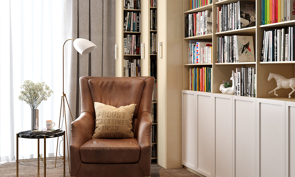 Low budget home decoration with bookshelves, a leather chair and a wooden floor.