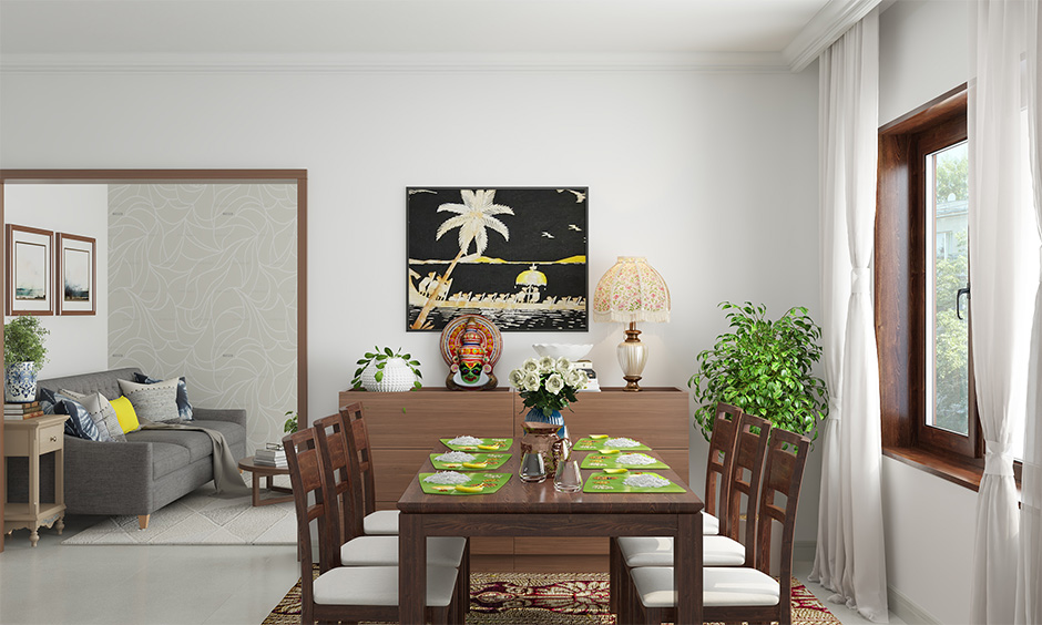 Onam decoration idea, dining table decorated with flowers and lamps lends traditional vibe.