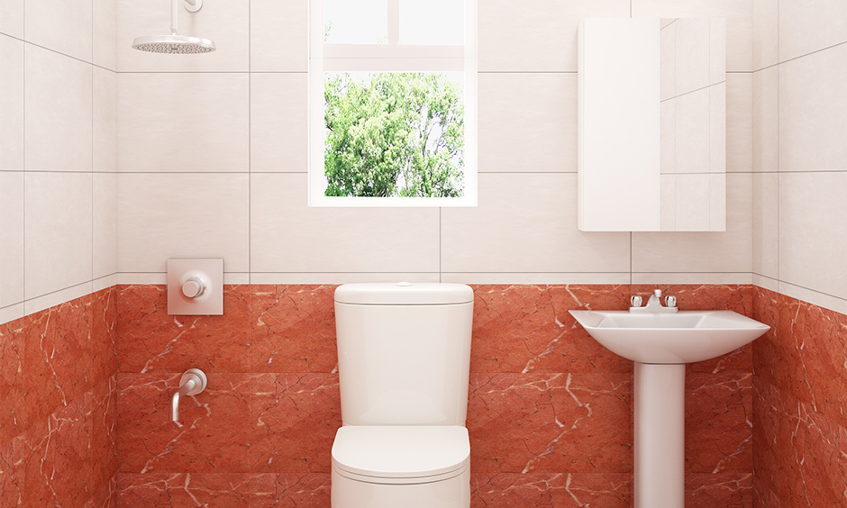 Orangish-red wall tiles in the bathroom with white colour tiles bring a soothing effect.