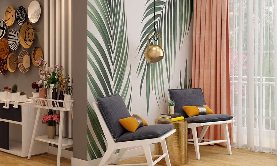 Living room Scandinavian wall decor with a leaf motif wallpaper and pendant light gives a nature vibe.