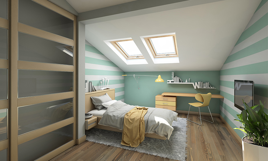 Aesthetic attic bedroom with single bed design, study table and roof windows creates the perfect cosy haven.