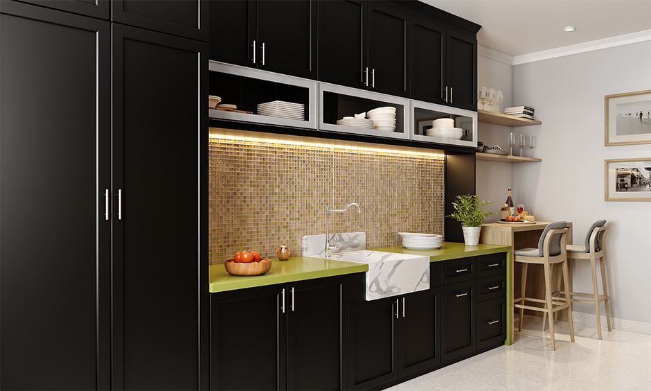 Straight modular kitchen designs with cabinets painted in black, the beige mosaic tiled backsplash