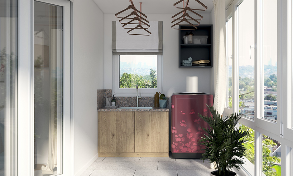 The balcony laundry room features an overhead cloth line, top-mount sink and a wooden base cabinet.