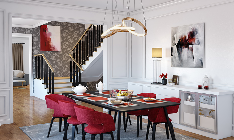 Rectangular black and red dining set in the white dining room with a fancy chandelier.