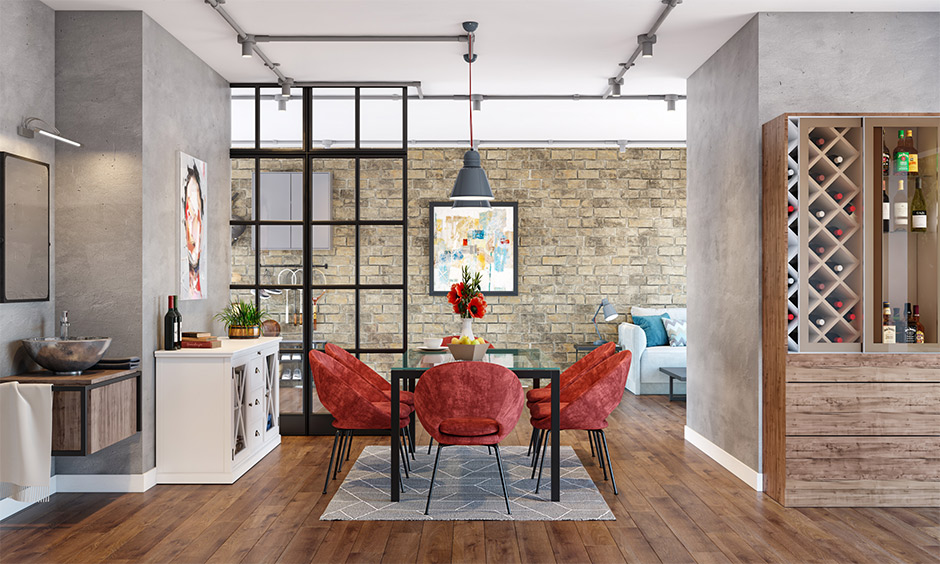 The glass table and red dining chairs in the dining room paired well with the medium-tone wood flooring.