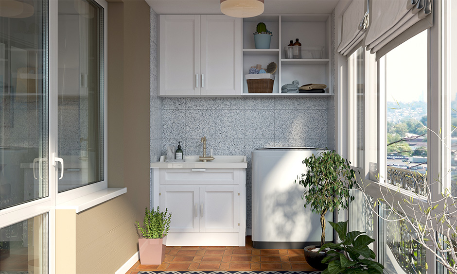 Laundry room design in balcony with a white cabinet and sliding window mechanism enhances the look.