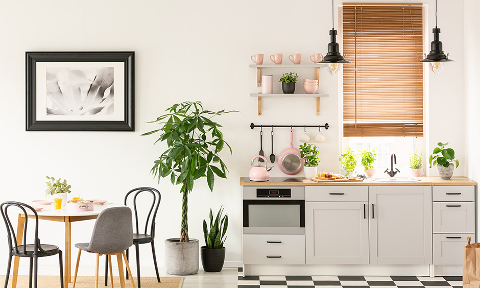 Small french kitchen cum dining area in a minimalist design with monochrome tile flooring.