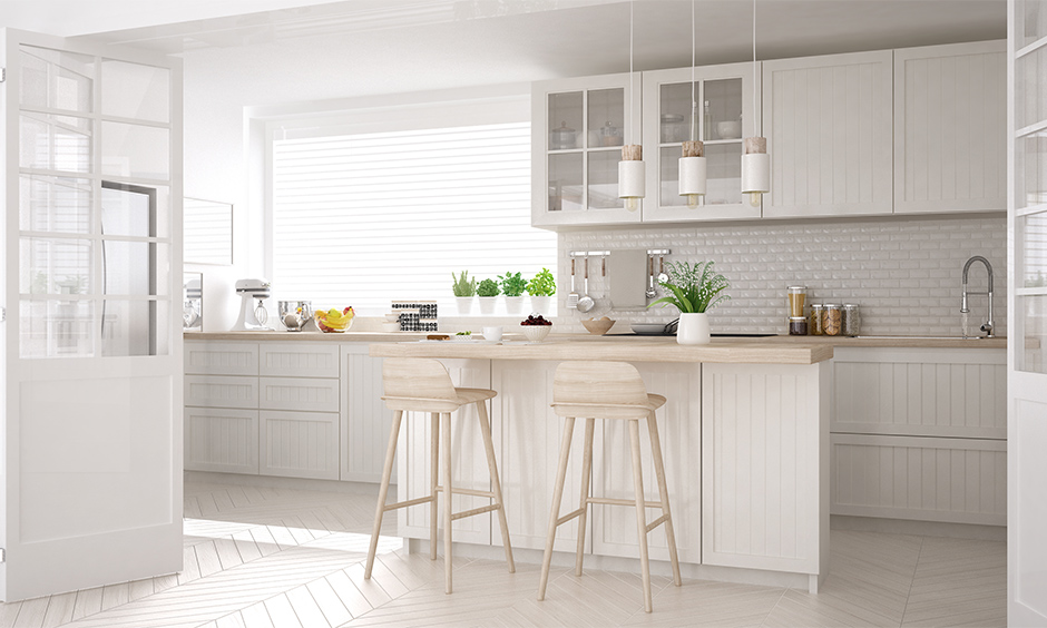 White kitchen in french style with rustic wooden furniture and flooring