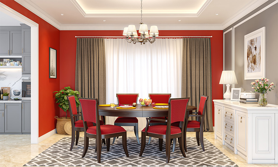 Dining room with an oval dining table and red upholstered dining chairs look new yet classy.