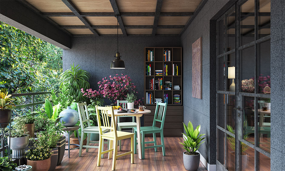 A set of wooden chairs and a table in green and yellow colours surrounded by plants is a simple outdoor furniture idea.