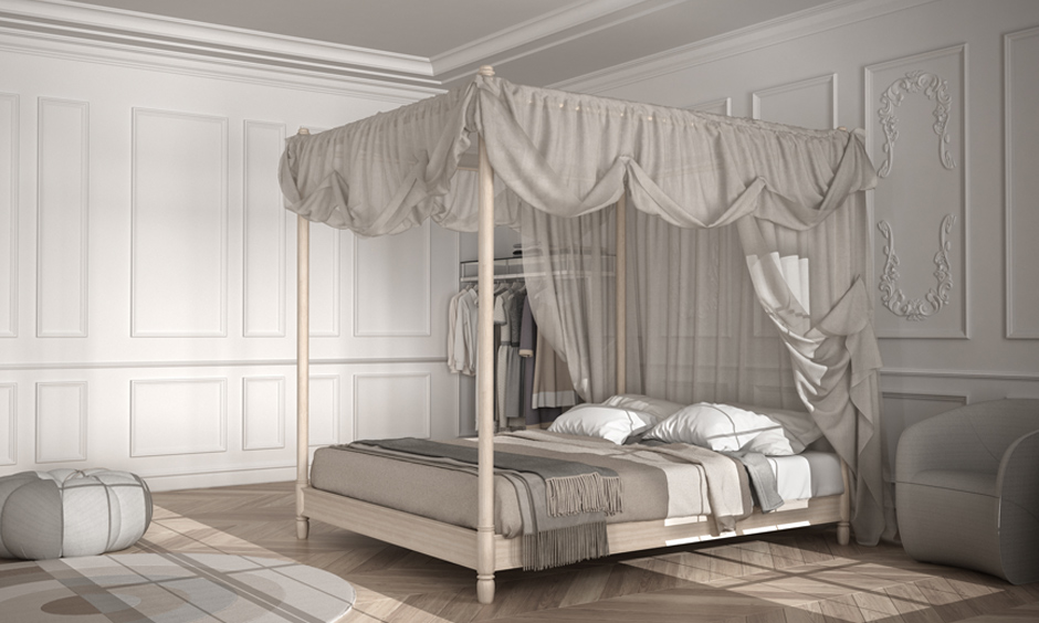 Canopy bed design with cream coloured frame and grey fabric